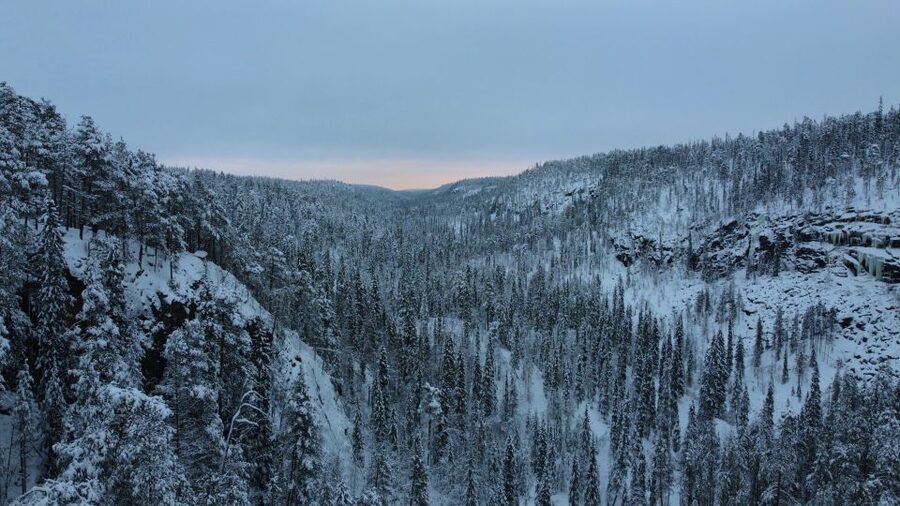 Korouoma: Frozen Waterfall Hiking Tour - Snow grips turn a slippery trail into a manageable one